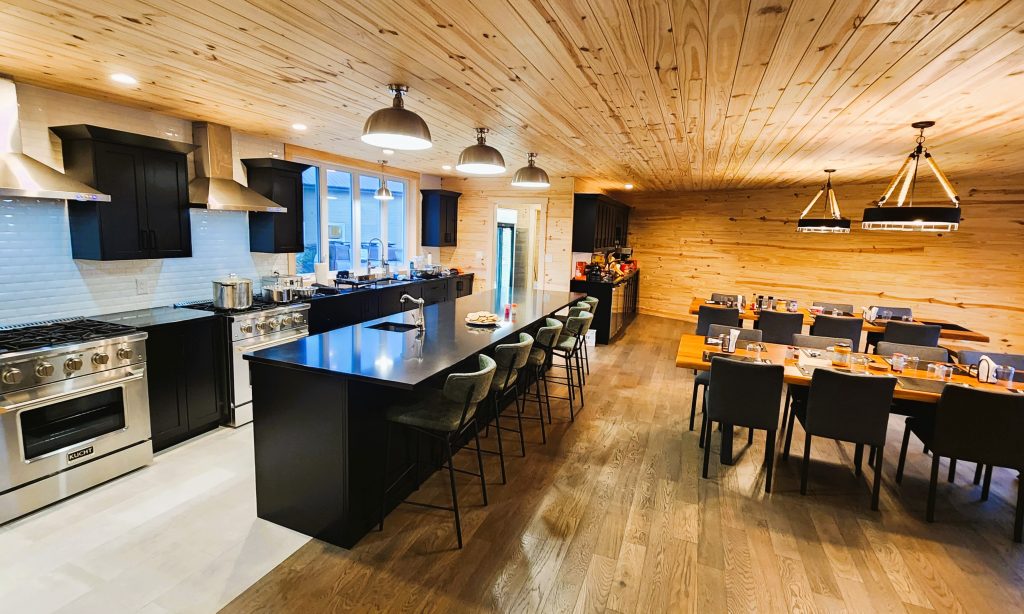 Open concept clean and modern kitchen and dining room ready to accommodate large groups for spectacular dining experience