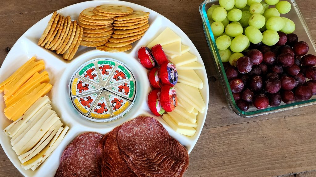 A tray of meat, cheese, and fruit rests on the coffee table in the gathering room for hunters to enjoy while resting at the Newfoundland lodge