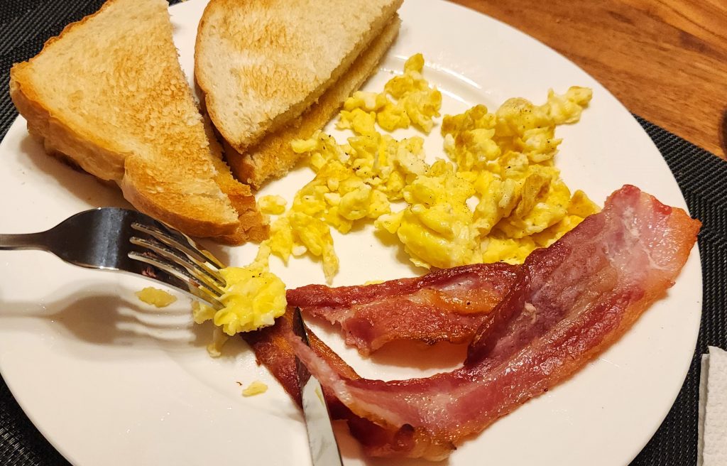 Close up of breakfast plate including bacon, eggs, and toast as part of a hearty breakfast provided for hunters at the Newfoundland Adventures lodge
