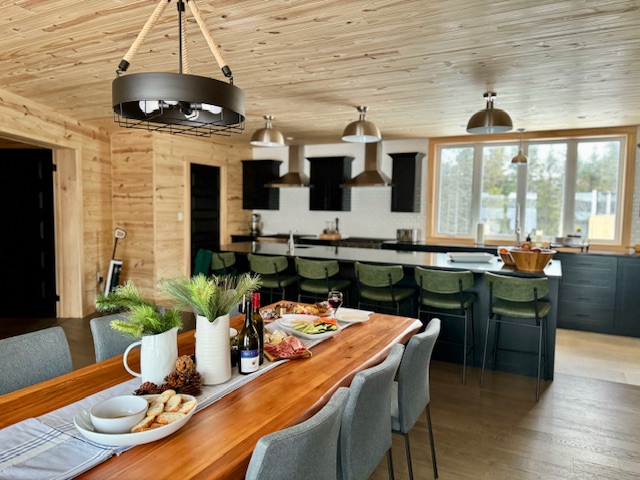 beautiful open-concept kitchen offers plenty of seating for large groups to enjoy home cooked meals at Newfoundland Adventures Lodge